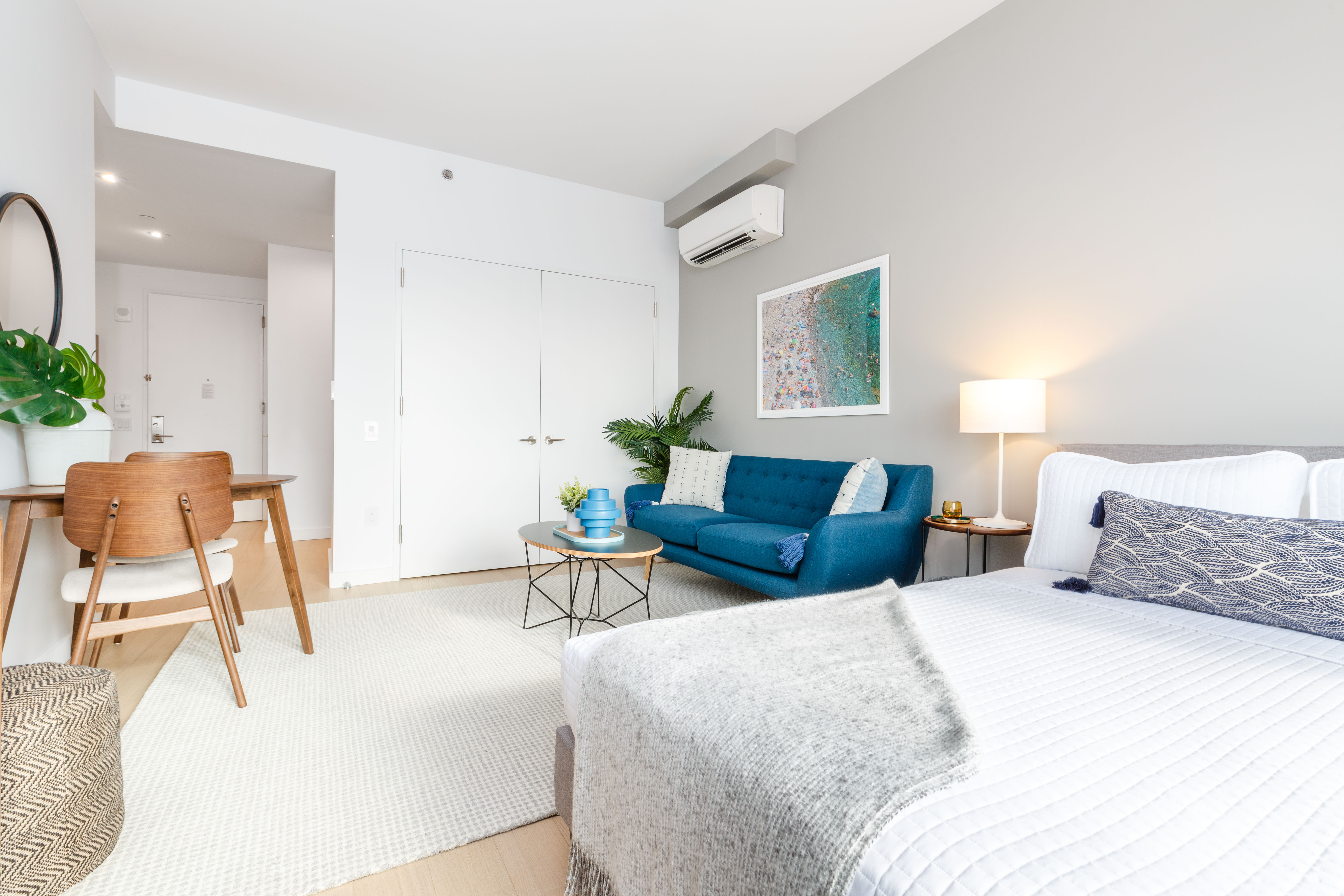 a bedroom with a bed and a chair in a room